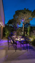 in-lite outdoor lighting across a terrace and garden in the evening